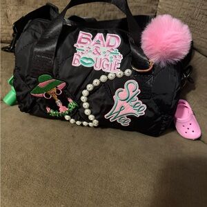 Black Duffel Bag with Pink Pom Pom and Patches